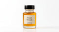 Sweet Woods perfume oil concentrate, amber liquid in a glass bottle with black cap and cream label